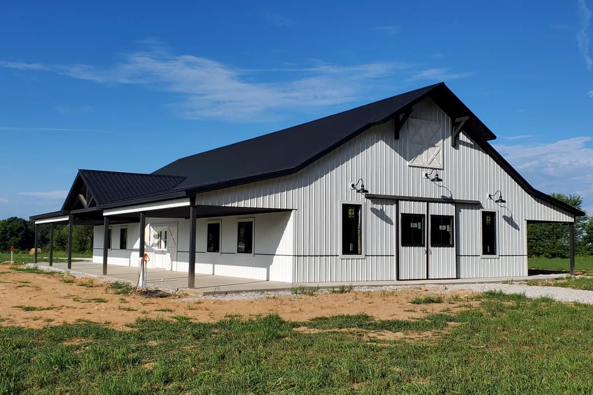 Barndominium with covered porch and cross-buck gable detail